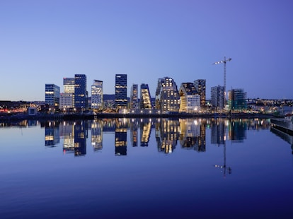 cityscape by water during golden hour