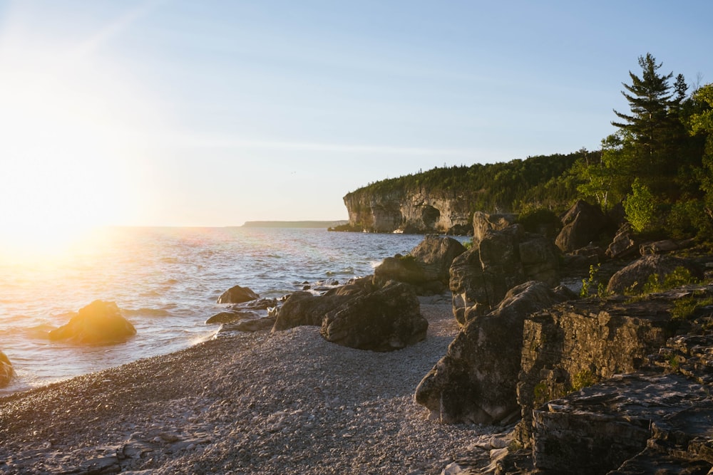 landscape photography of white sand rocky beach