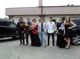 A group of well-dressed international travelers stepping out of a vipme luxury van.
