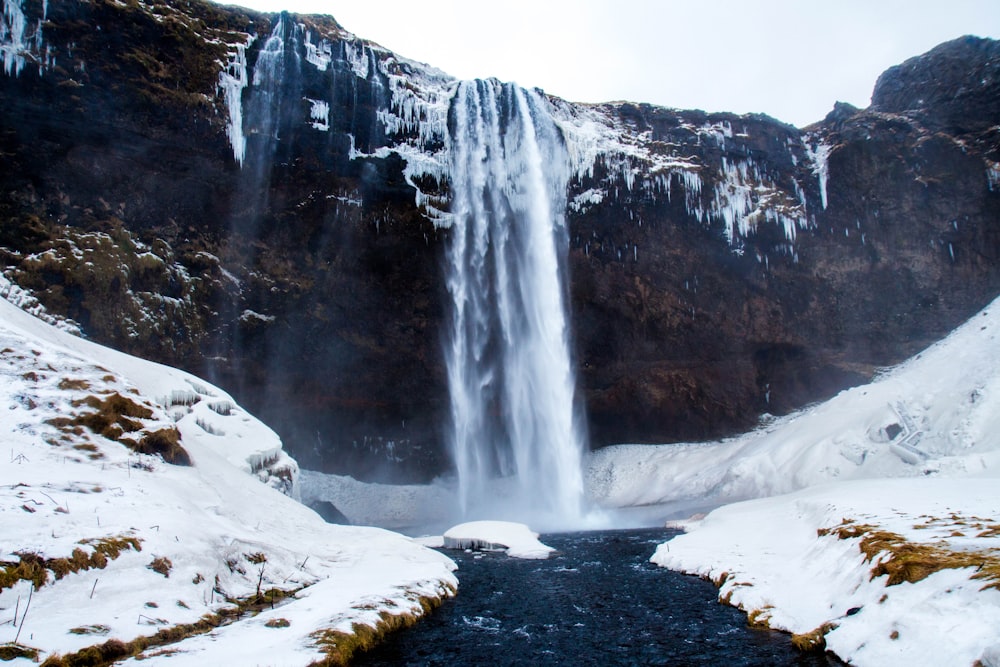 low-angle photography of waterfalls during winter