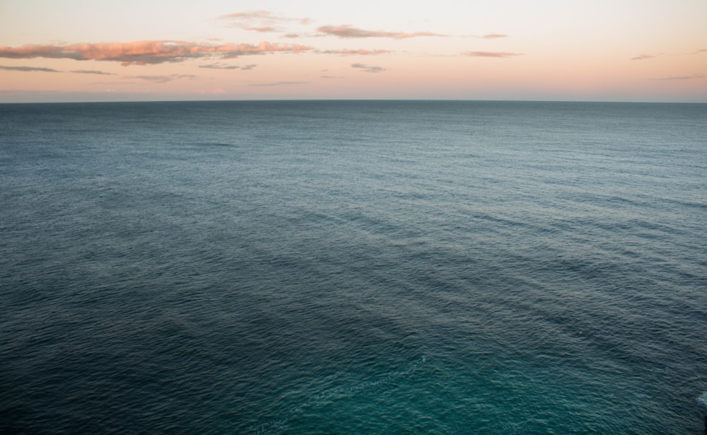 calm water under brown sky