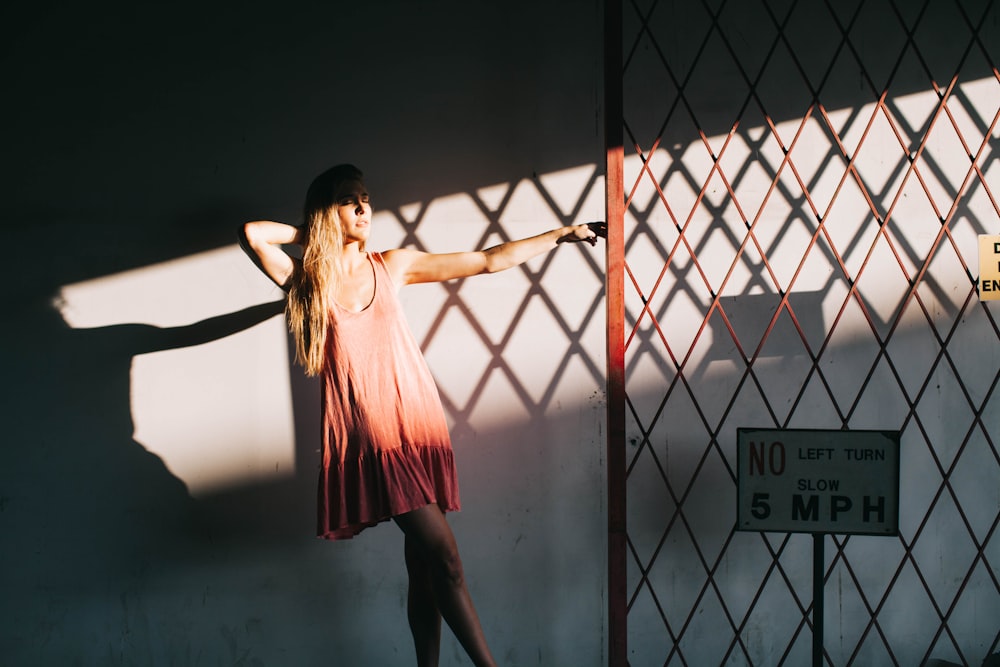 mujer sosteniendo una puerta de acero rojo