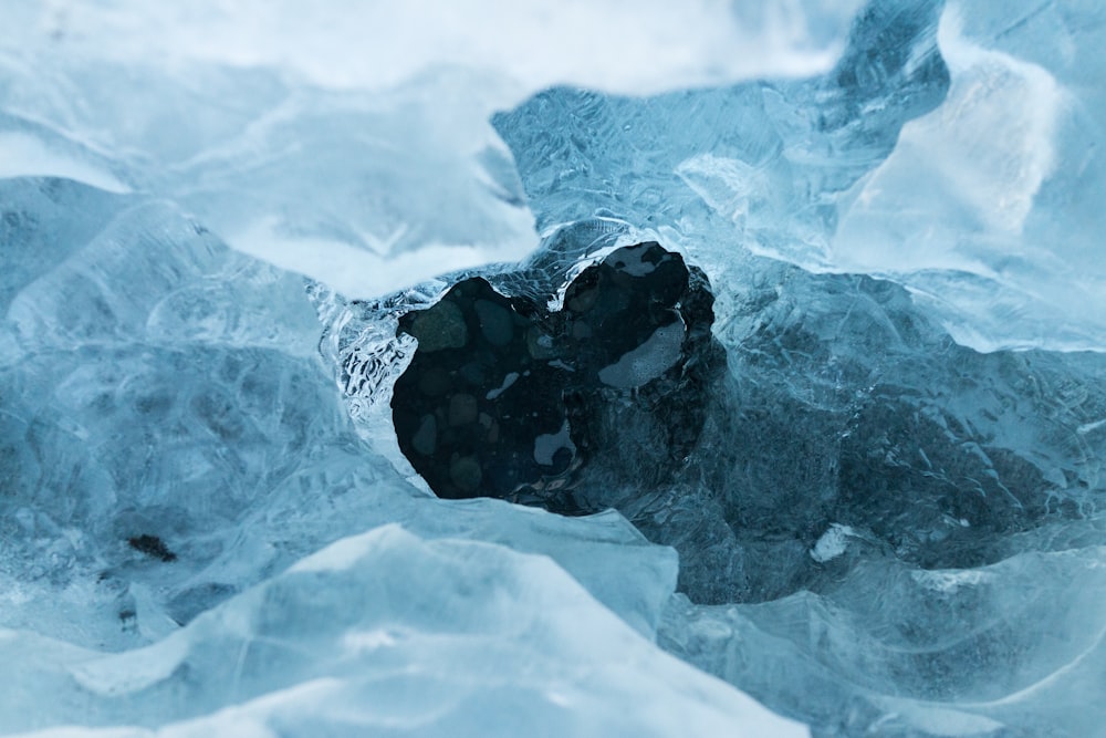 A hole in an ice sheet covering dark blue water