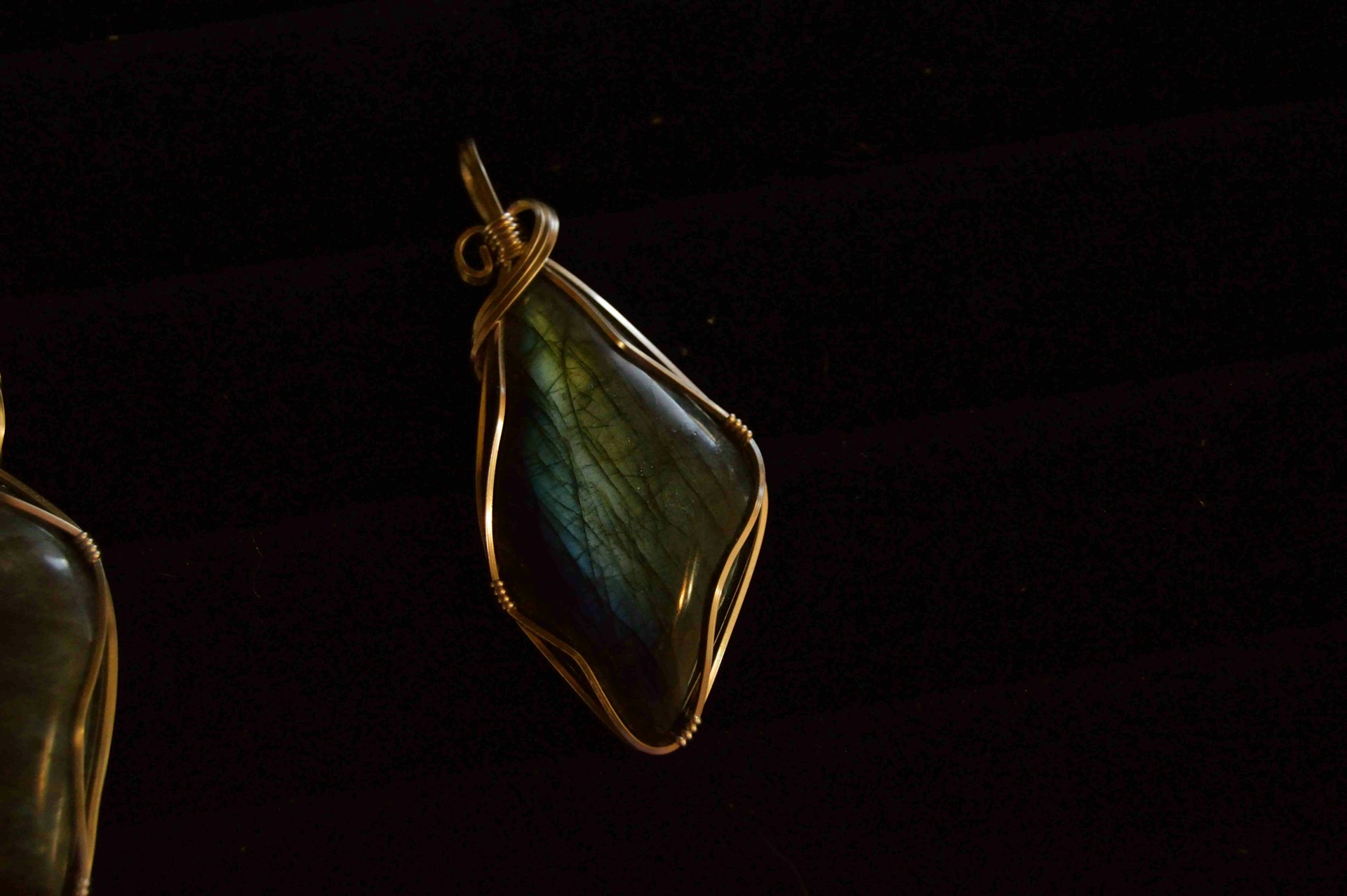 green gemstone wire wrap pendant with black background