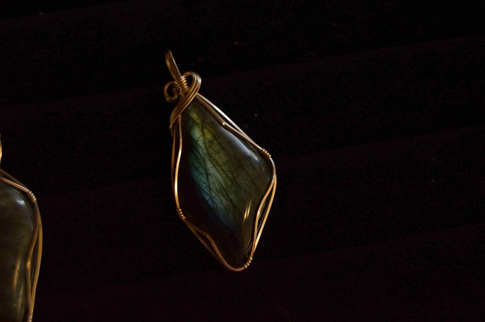 green gemstone wire wrap pendant with black background