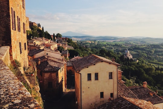 brown concrete houses on mountain at daytime in Montepulciano Italy