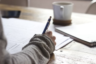 Nutrition counseling writing on brown wooden table near white ceramic mug in Michigan
