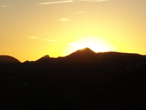 A breathtaking view of a mountain range during sunrise.
