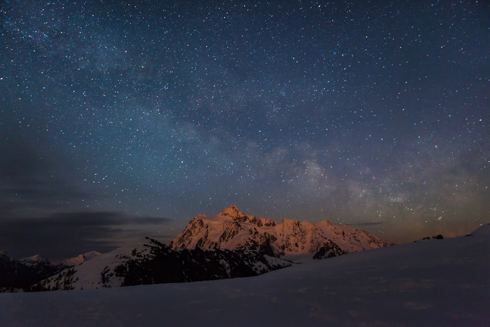 mountain covered with snow during nighttime view