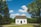 white wooden house between trees