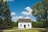 white wooden house between trees