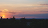 A vibrant sunset over a serene landscape.