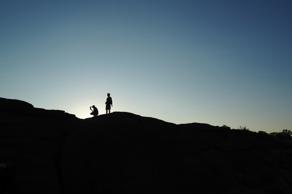 silhouette of person on hill