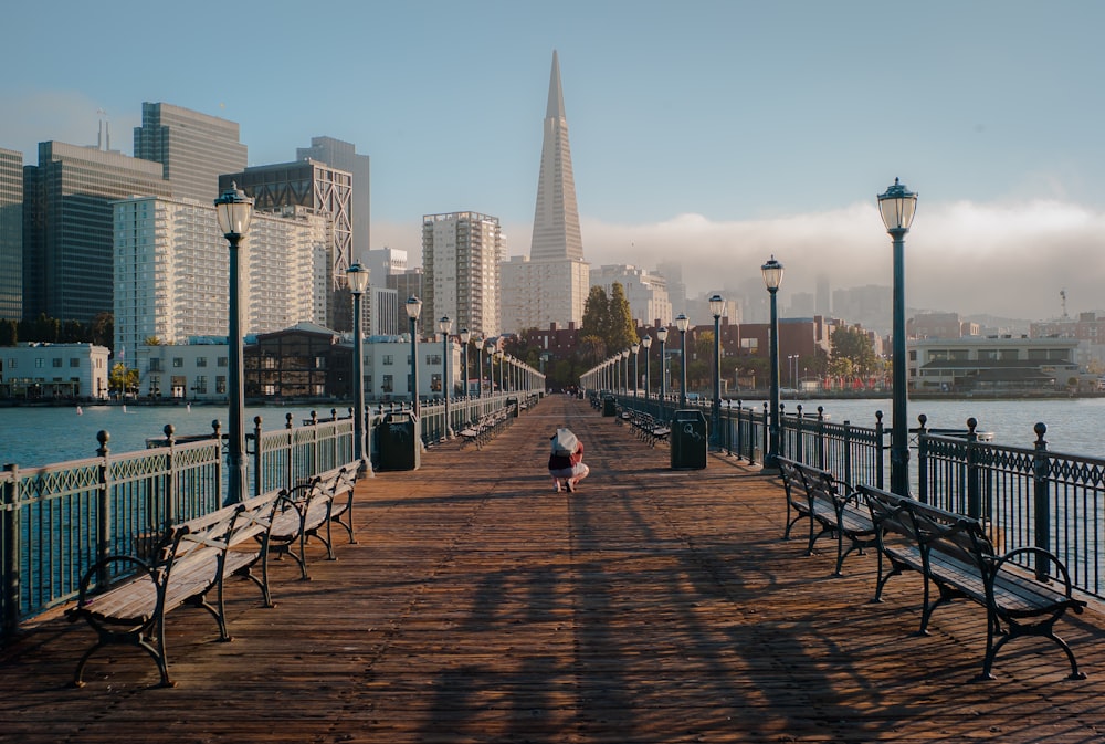 person on brown pathway towards building