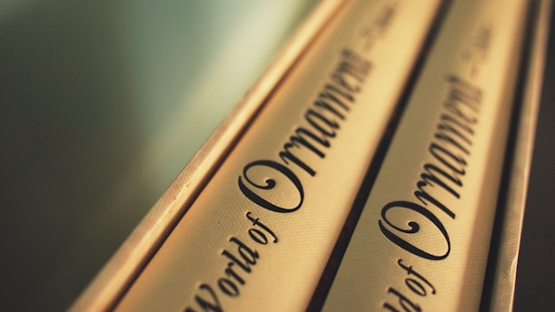 Close-up of a gold-accented book spine on a black and white background.