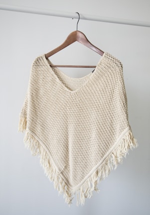 white v neck shirt on brown clothes hanger