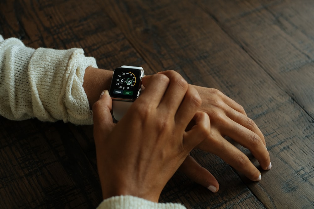 silver aluminum Apple Watch with white Sport Band