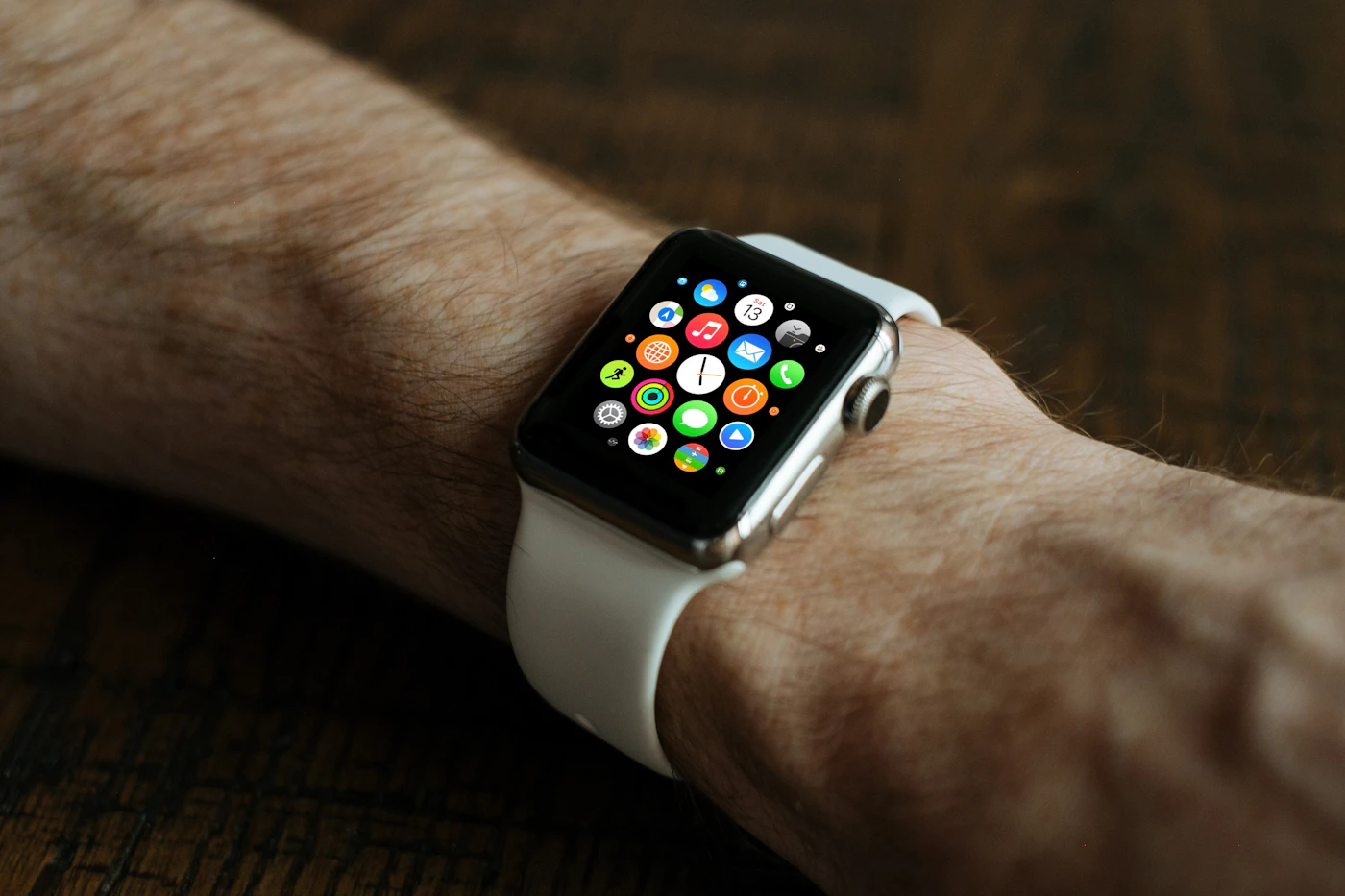 A person looking at a smartwatch while outdoors
