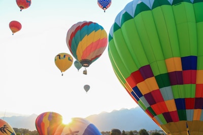 Colorful hot air balloons soaring over a serene valley at sunrise, capturing the thrill of adventure.