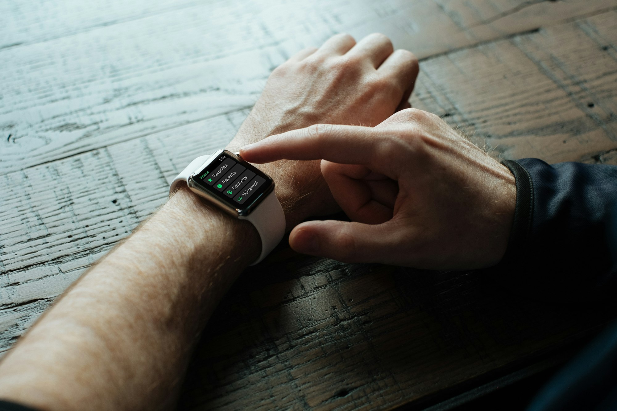 person touching Apple watch