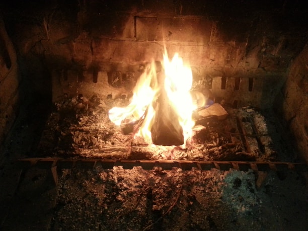 A cozy Marble Falls home with a freshly cleaned chimney and a warm fire glowing inside.