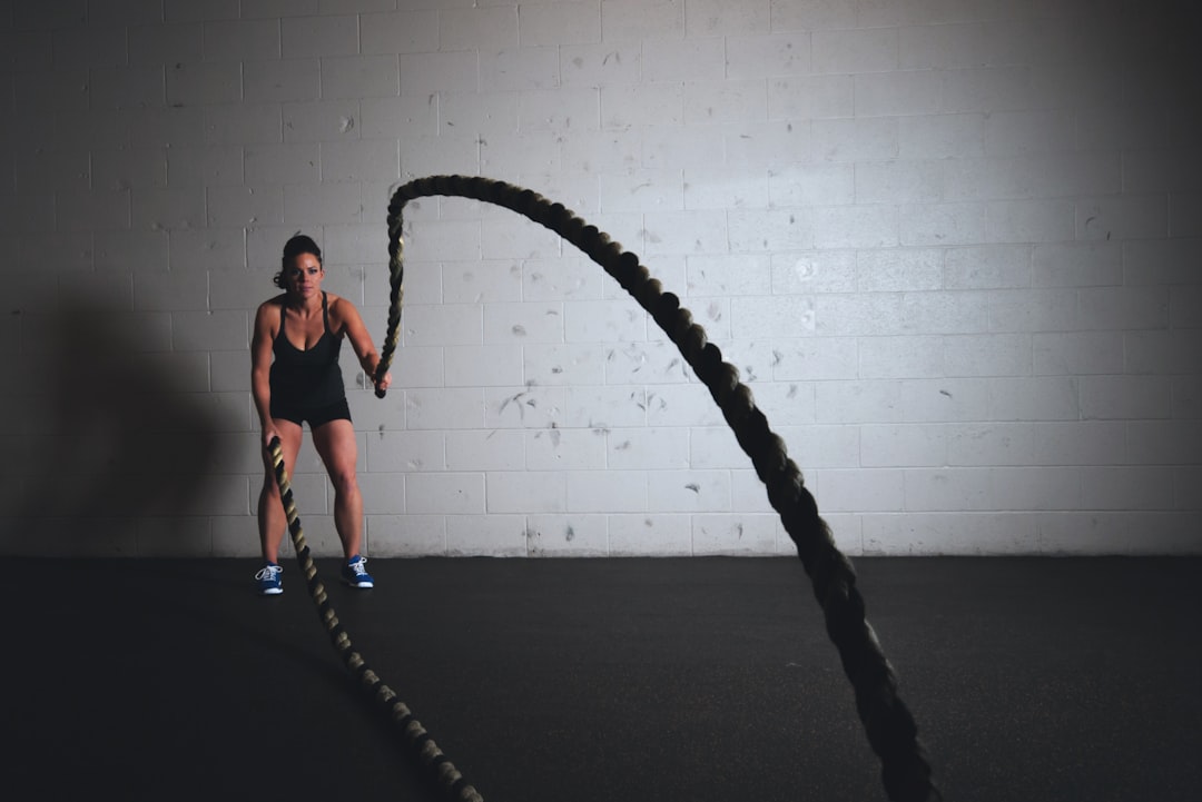 Woman working out with battle ropes and getting fit!