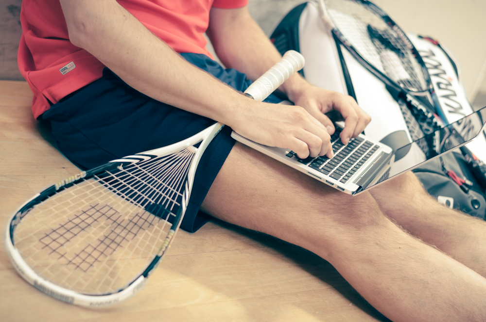 person wearing black shorts using laptop