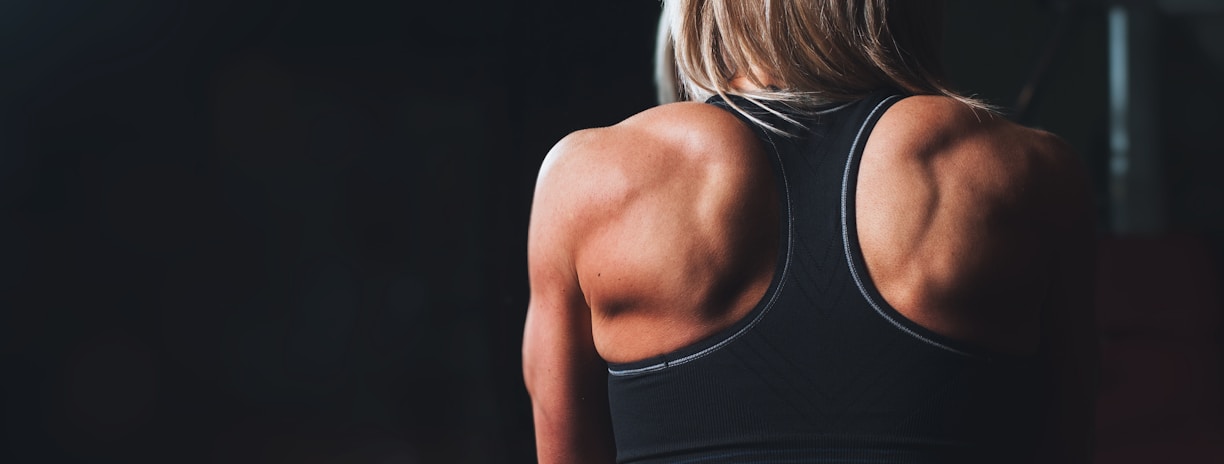 woman wearing black sports bra facing front selective focus photography