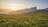 photo of green grass field at sunrise