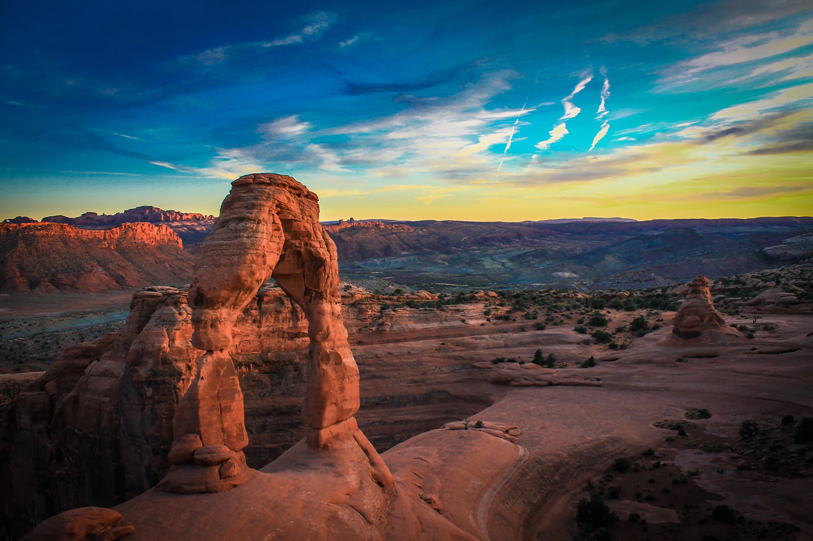 Delicate Arch on its slickrock bowl at sunset, near Moab