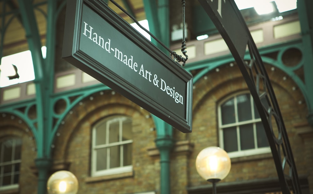 selective focus photo of Hand-made Art & Design signage