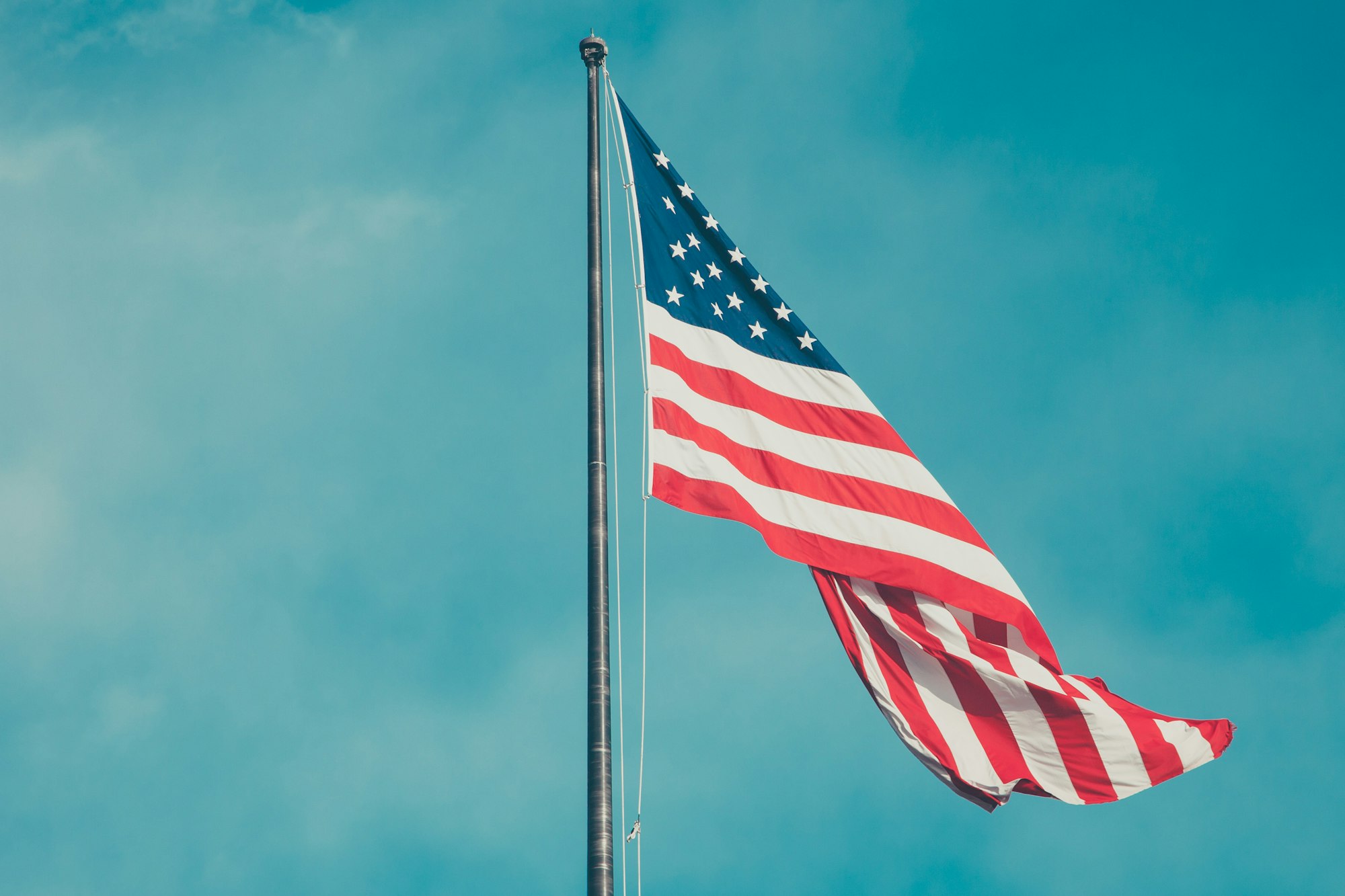 An American flag against a blue sky background
