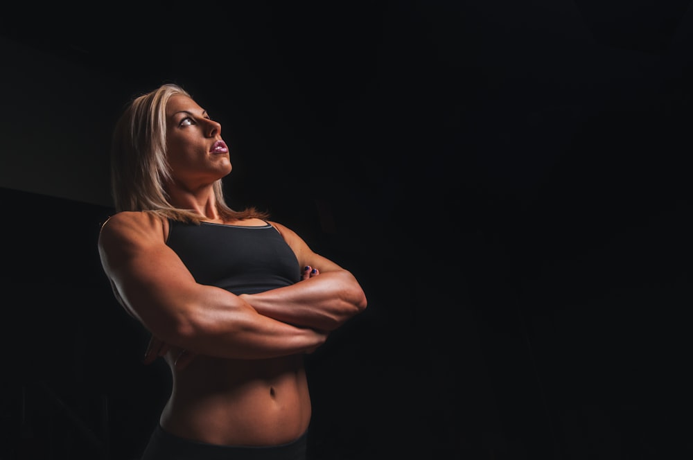 body builder woman wearing black crop-top cross armed closeup photography