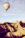 A happy woman enjoying a hot air balloon ride over scenic landscapes.