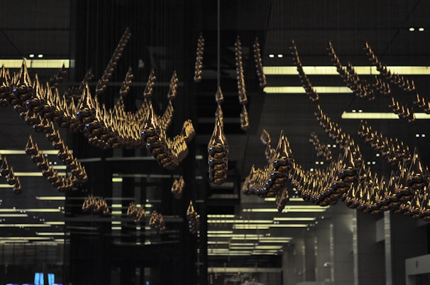 A professional art installation in a bright studio, highlighting the balance and symmetry of the hanging design.