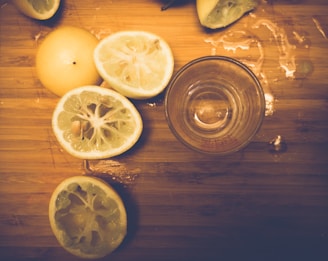 A close-up of freshly cut fermented lemons arranged on a wooden cutting board, highlighting their texture and vibrant color.