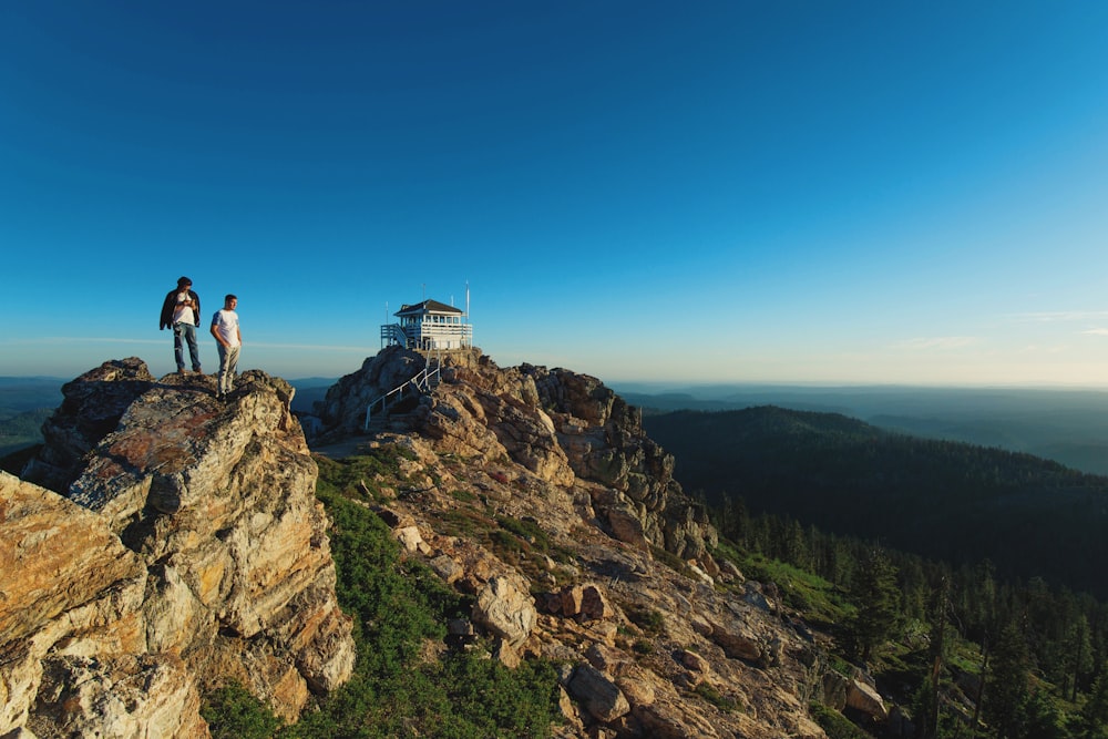 two men standing on rock formation