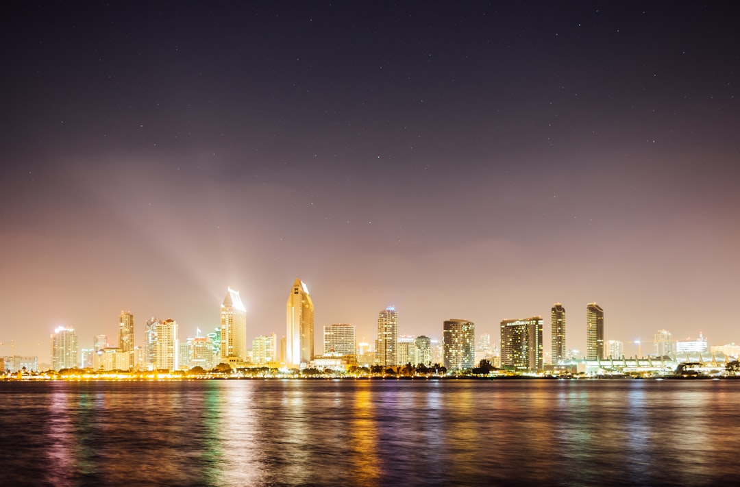 structural photo of high rise buildings near body of water,