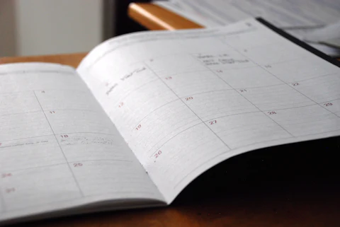 Open monthly planner on a desk, representing a seasonal maintenance checklist