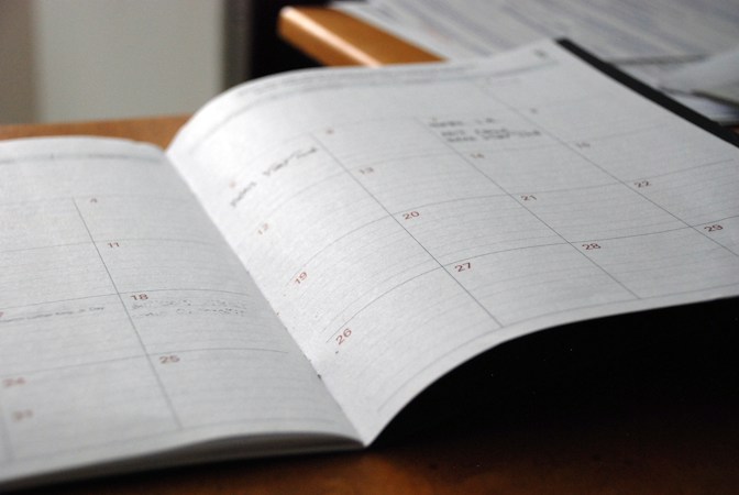 An open monthly planner on a wooden desk, a reminder that the Las Vegas best week to buy runs Oct. 4 to 10 while the national best week runs Sept. 27 to Oct. 3