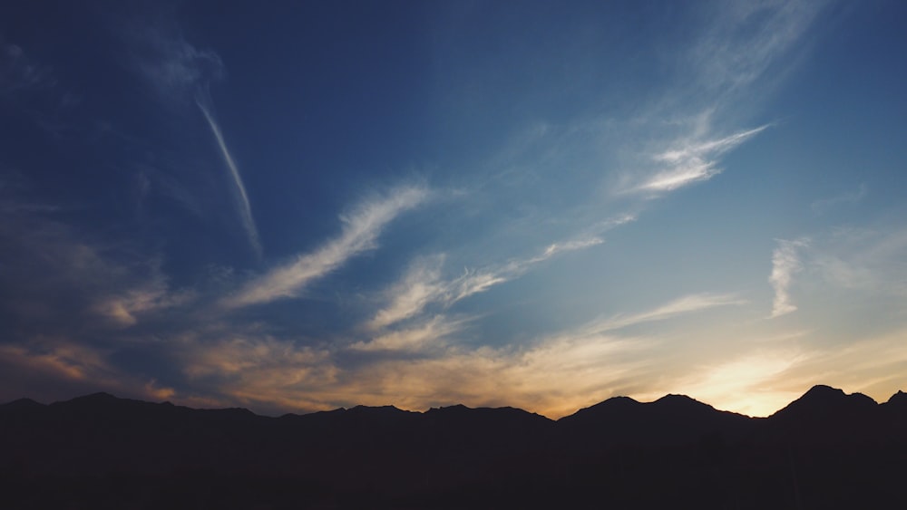 silhouette mountain range with golden time