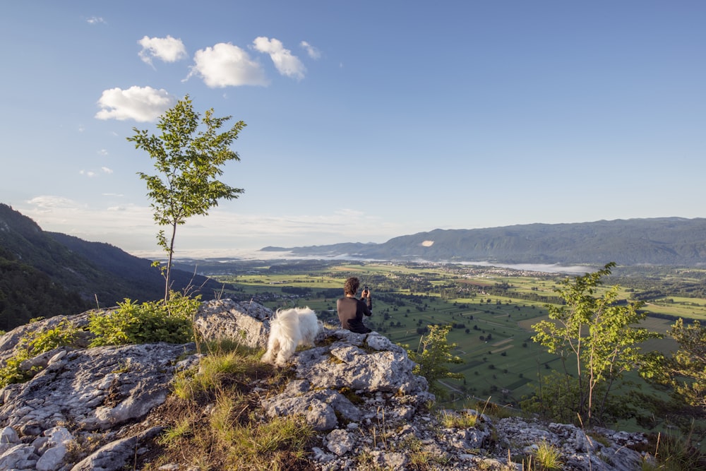 man sitting on the mountain cliff