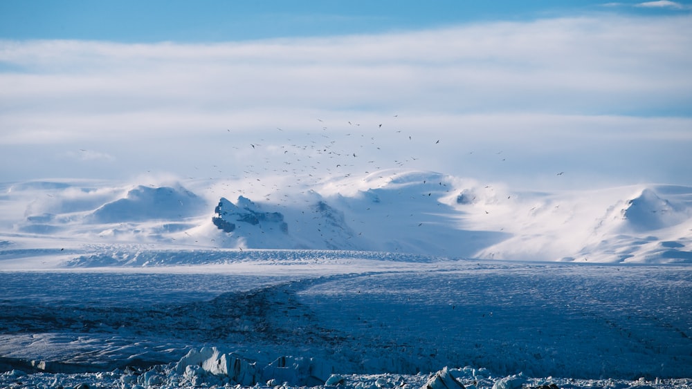 clear blue beside mountain covered with snow