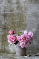 pink flowers on gray ceramic vase
