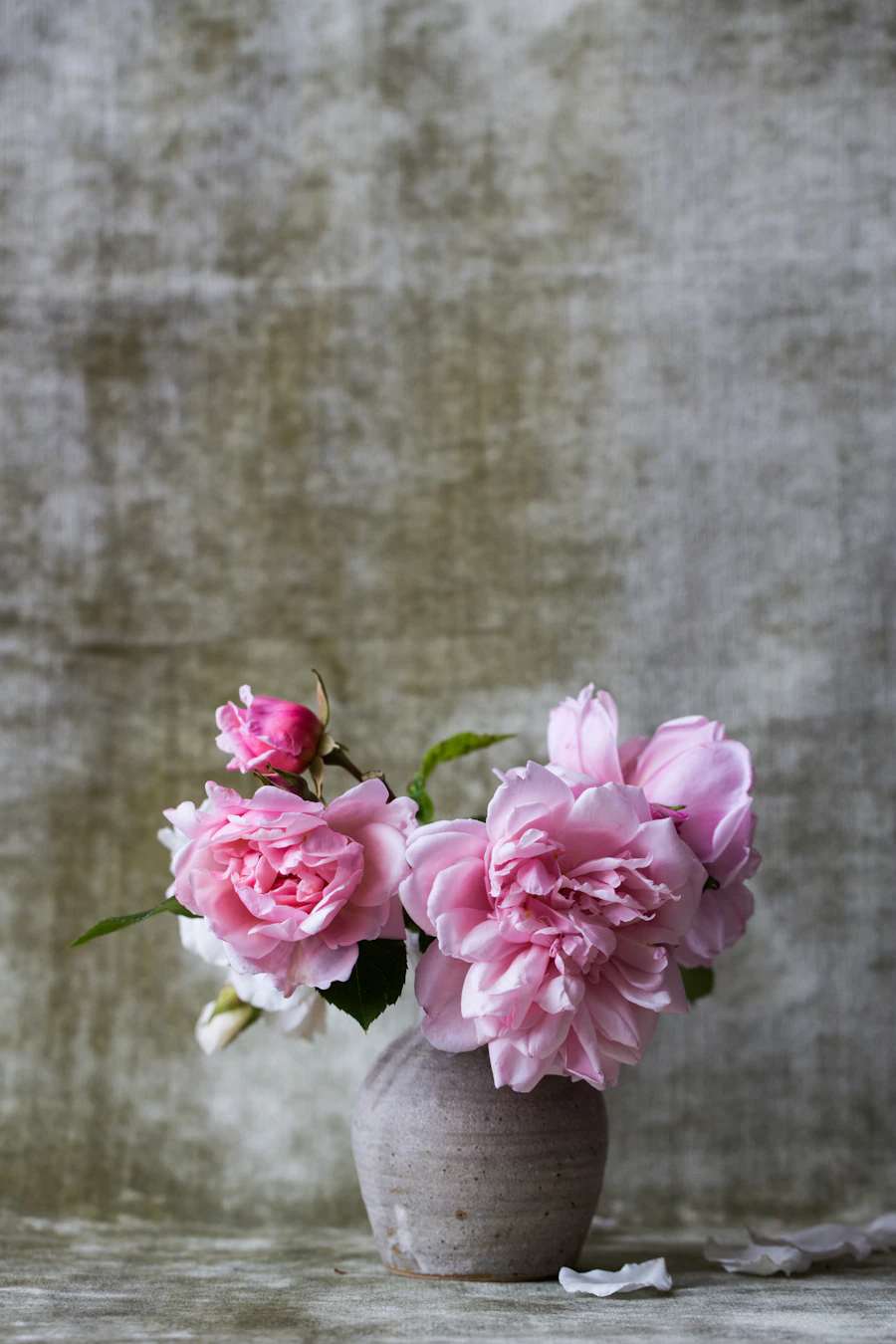 A gentle white-and-pink sympathy arrangement in a vase