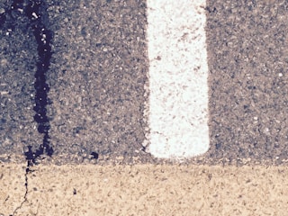 Close view of crack filling process on a commercial driveway.
