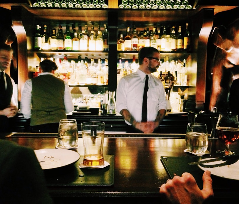 bartender standing beside table