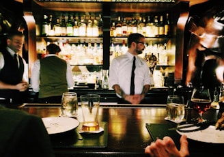 bartender standing beside table