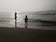 Children playing near Rainbow Beach with Lake Michigan’s waves gently rolling in.