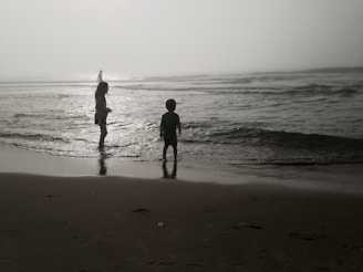 Children playing near Rainbow Beach with Lake Michigan’s waves gently rolling in.